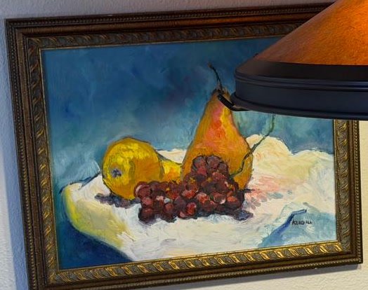 Susan Kendall still life painting of pear, grapes, and yellow fruit on a white cloth